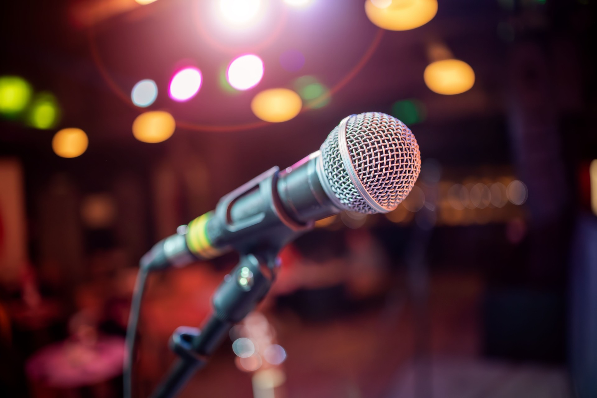 Microphone on stage against a background of auditorium.