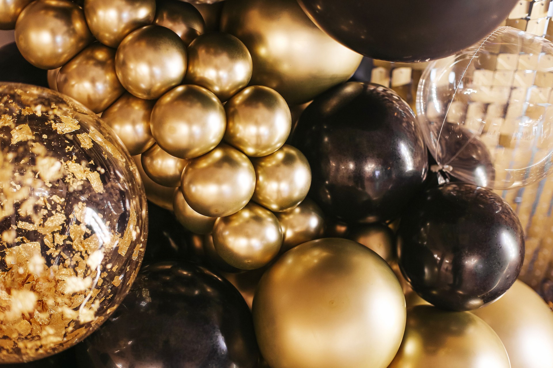 Decorative birthday photo wall. Gold and black balloons texture.