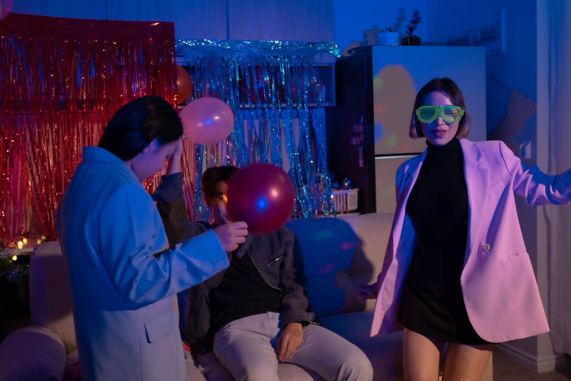 Group of young diverse millennial Asian friends with people dance together at home, celebrate New Year, Christmas, or Birthday at night. Happy celebration event, fun activity concept