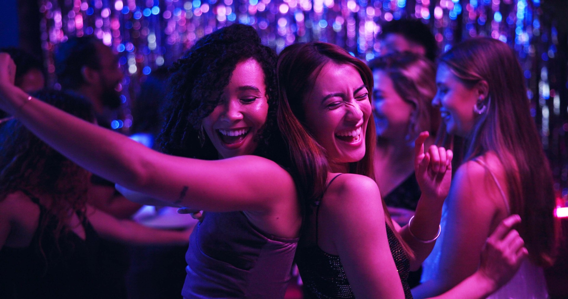 Dancing, energy and friends in club, night and fun for women, bonding and celebration in weekend or group. Lights, dark and listening to music, smile and people in rave, disco or festival on New Year